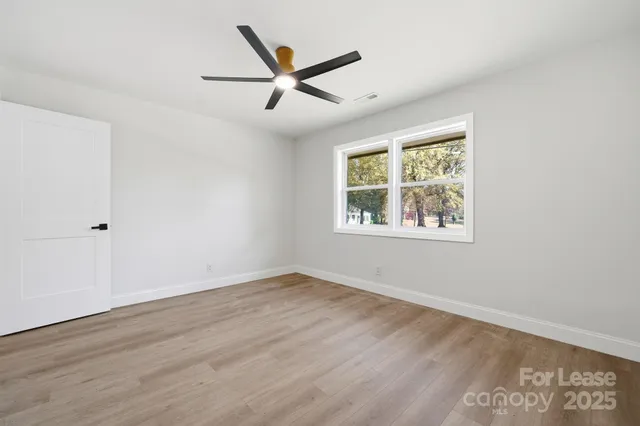 a view of a big room with wooden floor and closet area