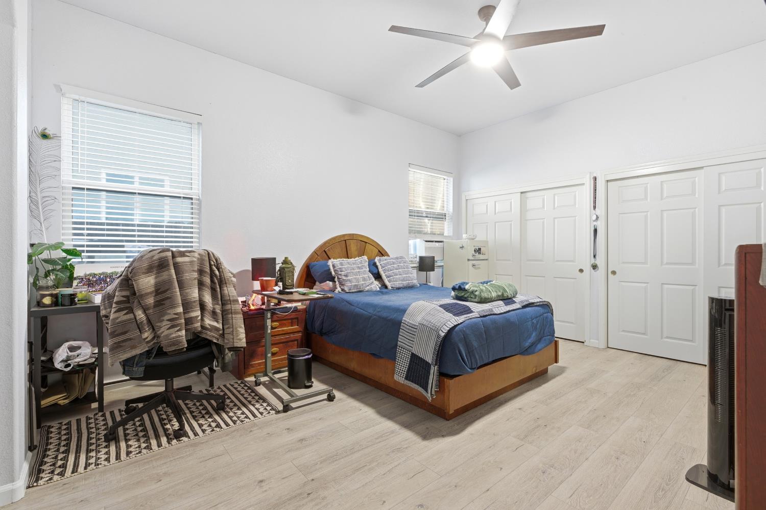 5412 Port Alice Way Salida, CA 95368 - Photo 17 of 37 a spacious bedroom with a bed a table and windows