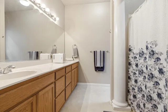 a bathroom with a double vanity sink and mirror