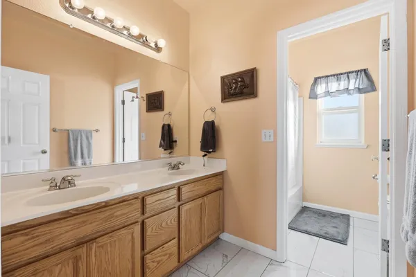 a bathroom with a double vanity sink and a mirror