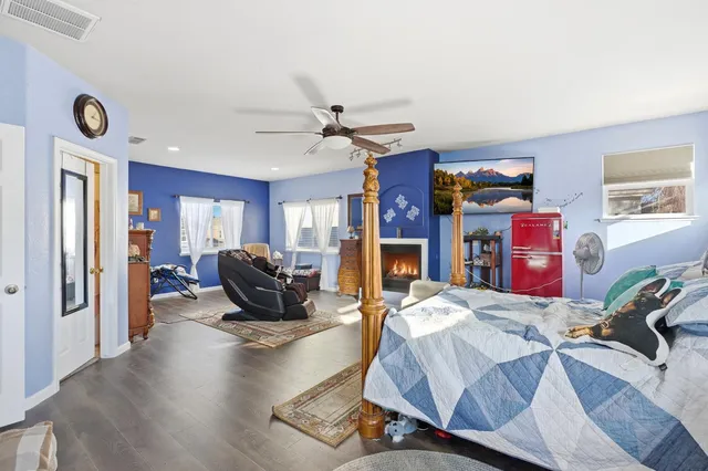 a living room with furniture flat screen tv and a fireplace