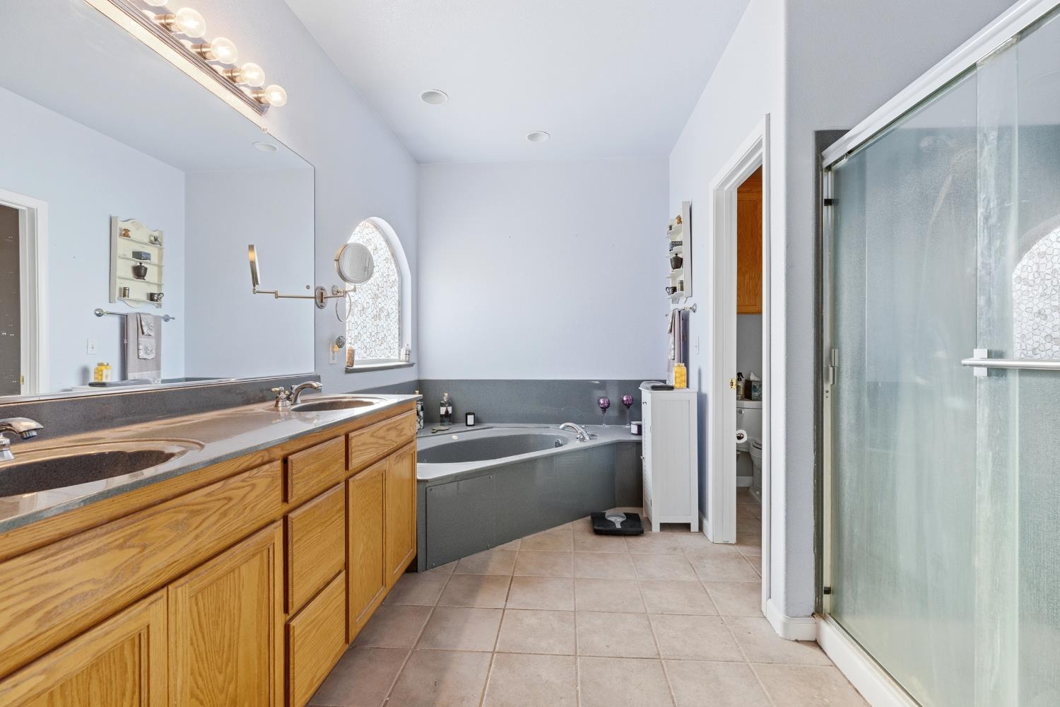 5412 Port Alice Way Salida, CA 95368 - Photo 25 of 37 a large bathroom with a tub sink and mirror