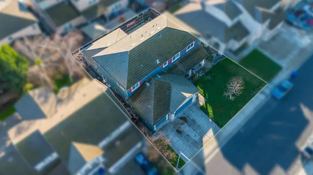 an aerial view of a house with a yard
