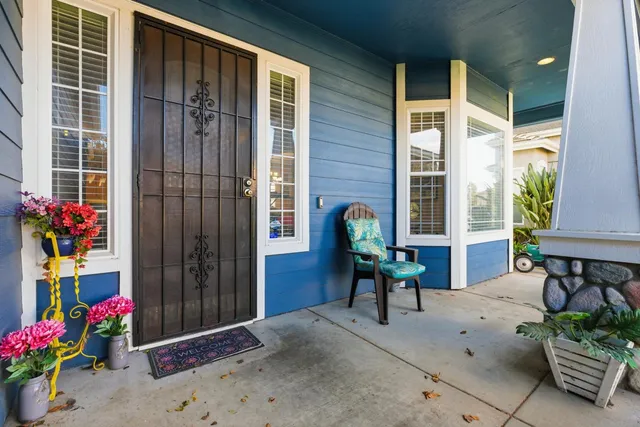 a view of a house with a backyard and a chair