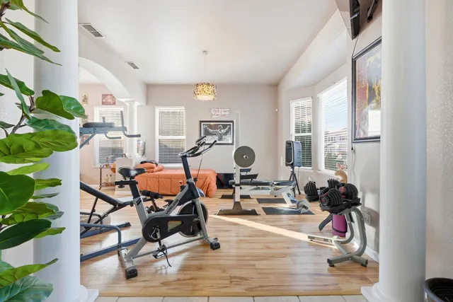 a view of a workspace with furniture and a window