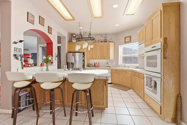 a kitchen with stainless steel appliances kitchen island granite countertop a sink and cabinets