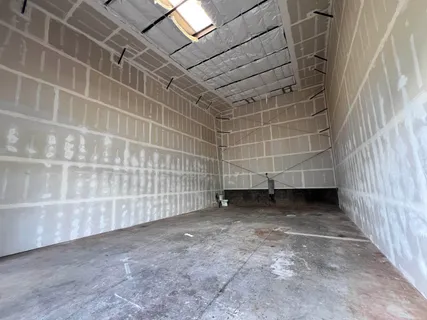 a view of a room with wooden shelves
