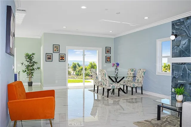 a workspace room with furniture and a potted plant