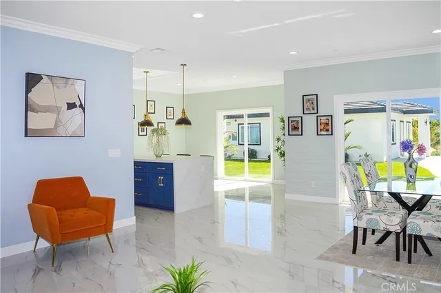 a view of a dining room with furniture and a potted plant