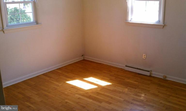 102 East Fourteenth Avenue Ranson, WV 25438 - Photo 8 of 9 an empty room with wooden floor and windows