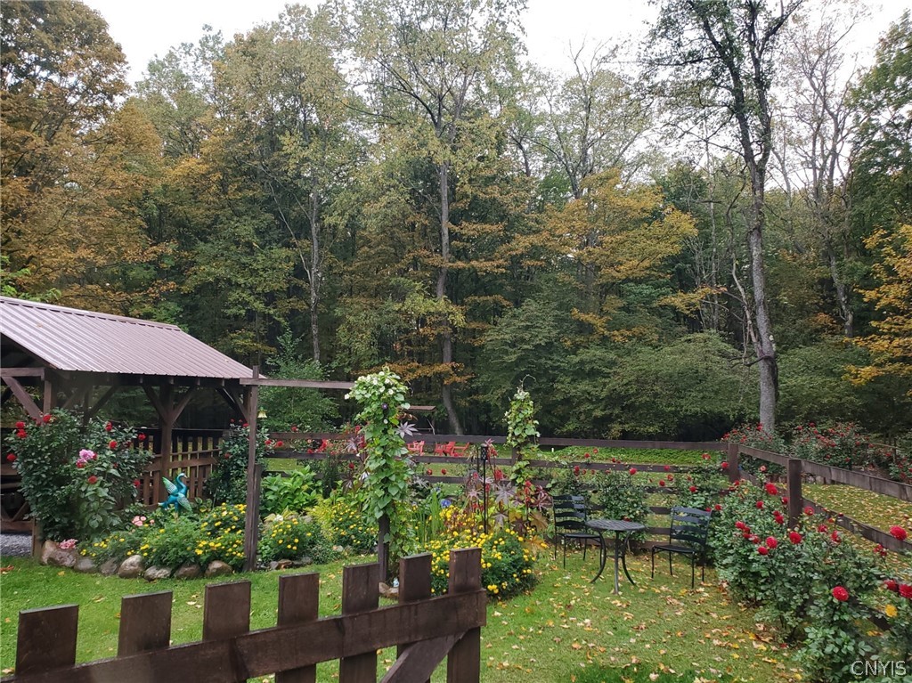 1053 Grant Road Russia, NY 13324 - Photo 36 of 47 Lush garden beds and a rustic gazebo stand before