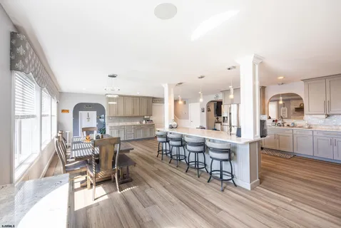 a bathroom with a granite countertop sink mirror vanity and toilet