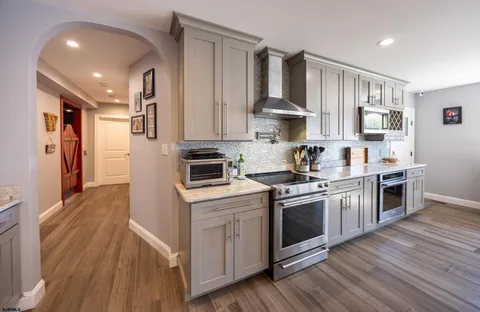 a bedroom with a bed and a refrigerator
