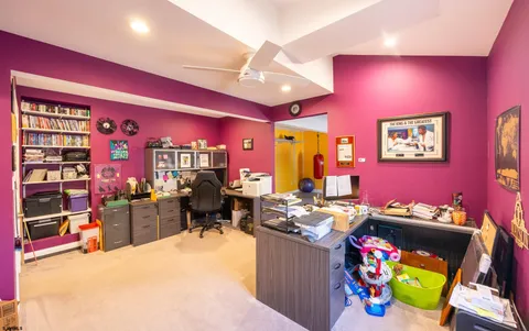 a spacious bedroom with a bed and a flat screen tv