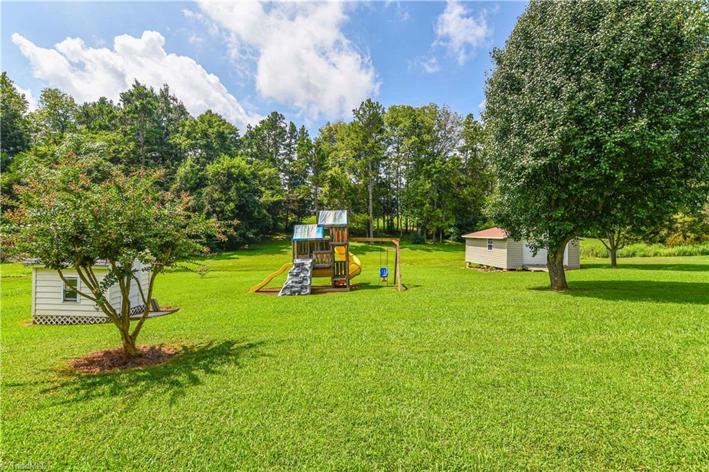 4215 Finch Farm Road Trinity, NC 27370 - Photo 26 of 30 Back yard with playhouse, jungle gym & storage building.