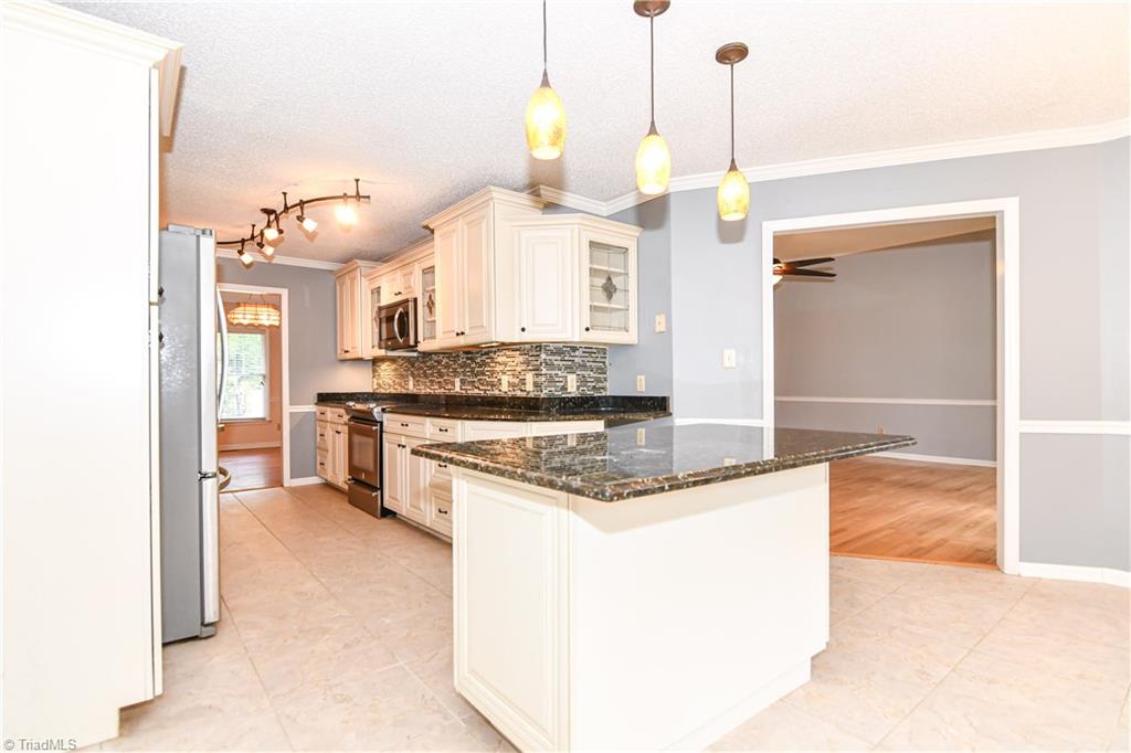 4215 Finch Farm Road Trinity, NC 27370 - Photo 7 of 30 Kitchen island with pendant lighting.