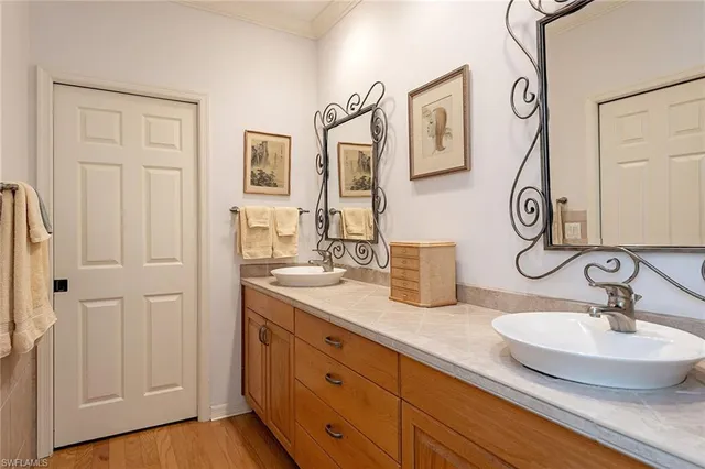 a bathroom with double vanity sinks and a mirror