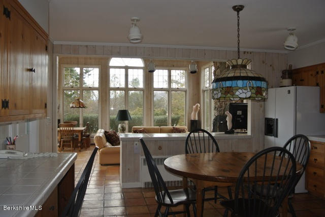 25 Prospect Hill Road Stockbridge, MA 01262 - Photo 12 of 30 a dining room with furniture a chandelier and window
