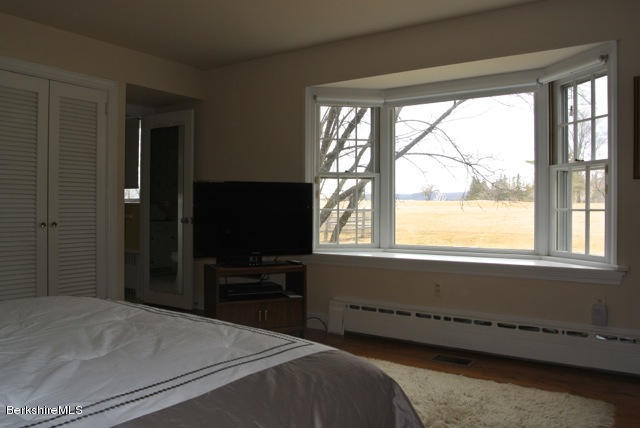 25 Prospect Hill Road Stockbridge, MA 01262 - Photo 13 of 30 a bedroom with a bed and a flat tv screen next to a window