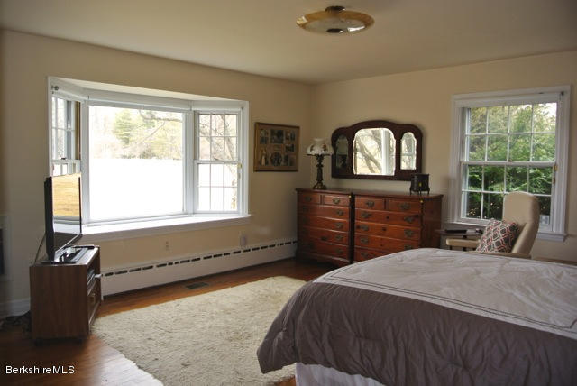 25 Prospect Hill Road Stockbridge, MA 01262 - Photo 14 of 30 a bedroom with a bed and a dresser next to a window