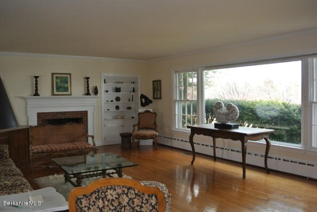 25 Prospect Hill Road Stockbridge, MA 01262 - Photo 9 of 30 a living room with furniture a large window and a fireplace