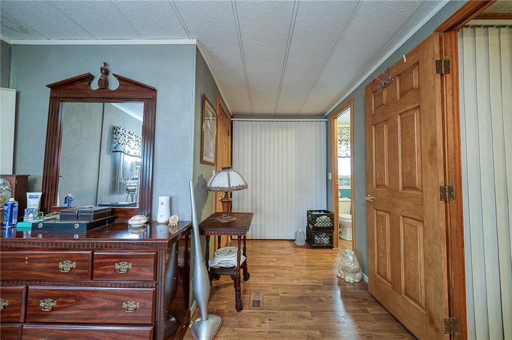 120 Purvis Road Butler, PA 16001 - Photo 14 of 27 a view of a hallway with wooden floor and furniture