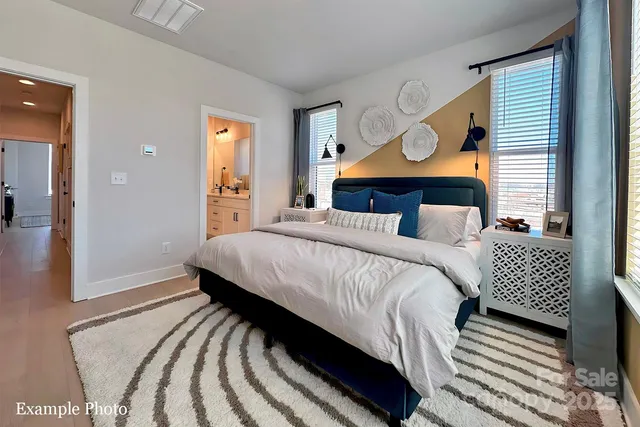 a bedroom with bed and wooden floor