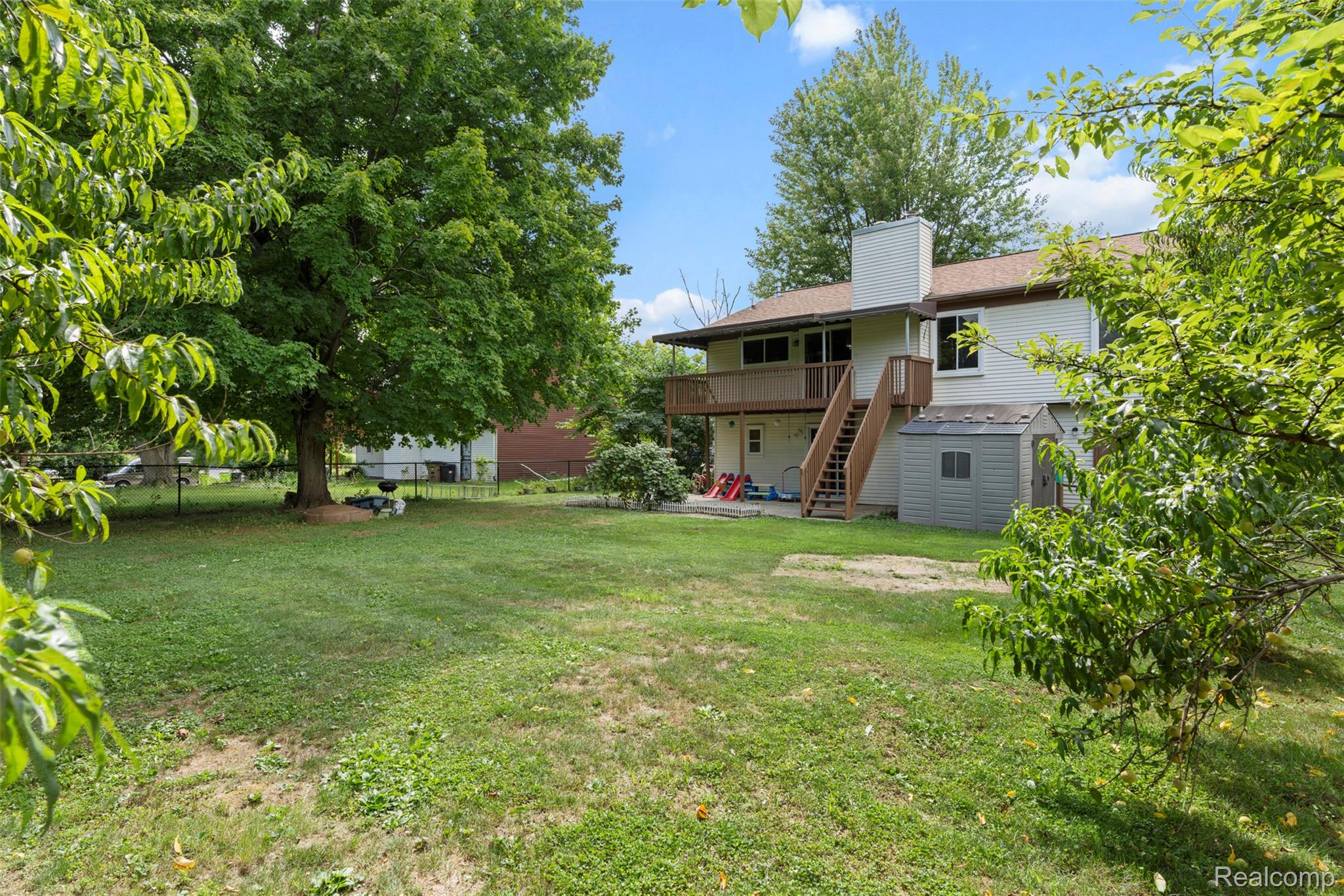 22530 Sheridan Road Novi, MI 48375 - Photo 27 of 50 View of yard with stairs, a deck, and a patio
