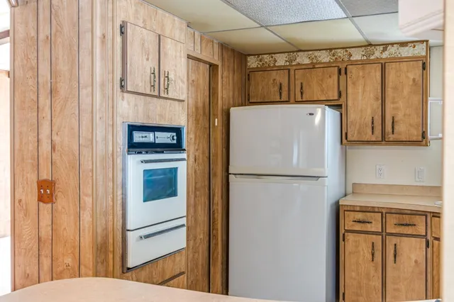 a view of a big room with wooden floor and a ceiling fan