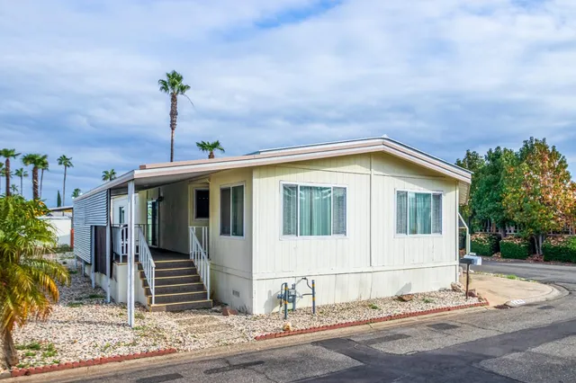 a front view of a house with a garden