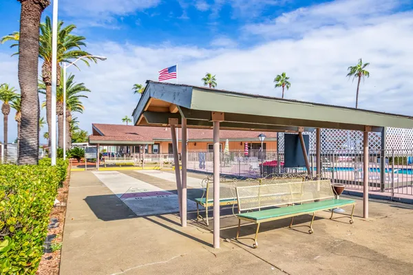 a front view of multiple houses with yard