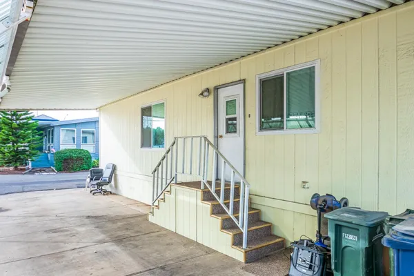 a view of a house with backyard and deck