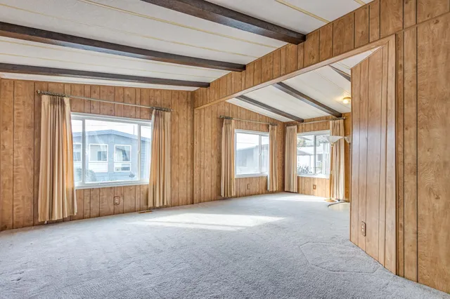 a view of a big room with windows and chandelier