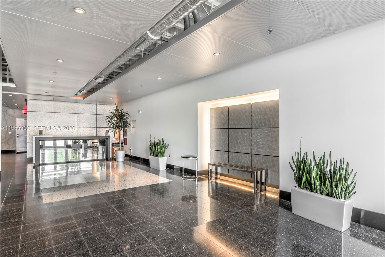8101 Biscayne Boulevard, Unit R613 Miami, FL 33138 - Photo 15 of 33 a lobby with furniture and potted plants