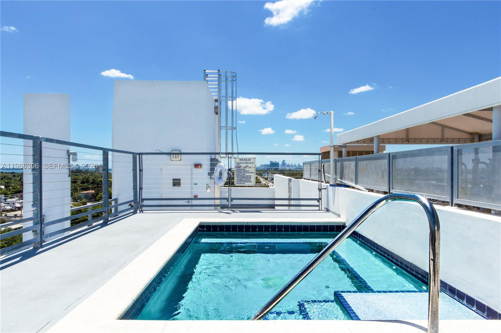 8101 Biscayne Boulevard, Unit R613 Miami, FL 33138 - Photo 22 of 33 a kitchen with kitchen island granite countertop a stove a sink and a table with wooden floor
