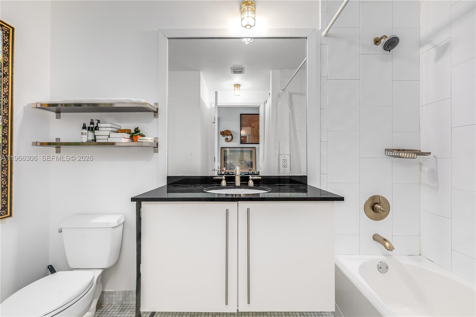 8101 Biscayne Boulevard, Unit R613 Miami, FL 33138 - Photo 32 of 33 a bathroom with a granite countertop sink a toilet and shower