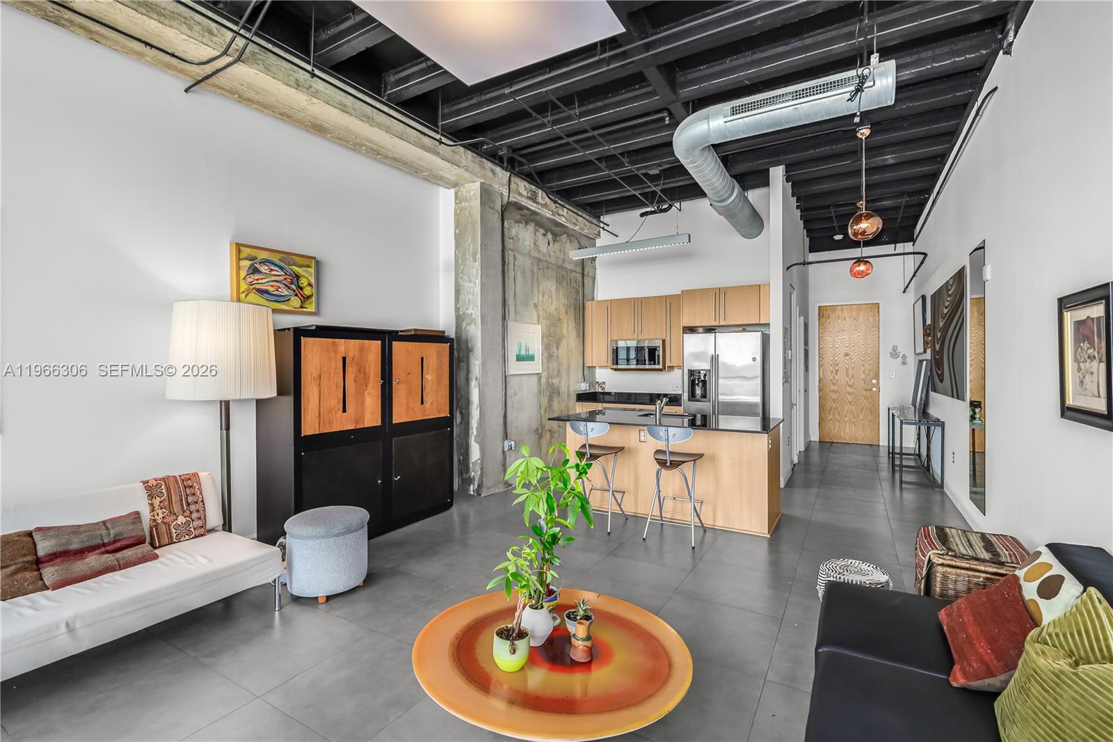 8101 Biscayne Boulevard, Unit R613 Miami, FL 33138 - Photo 4 of 33 a living room with furniture and a wooden floor