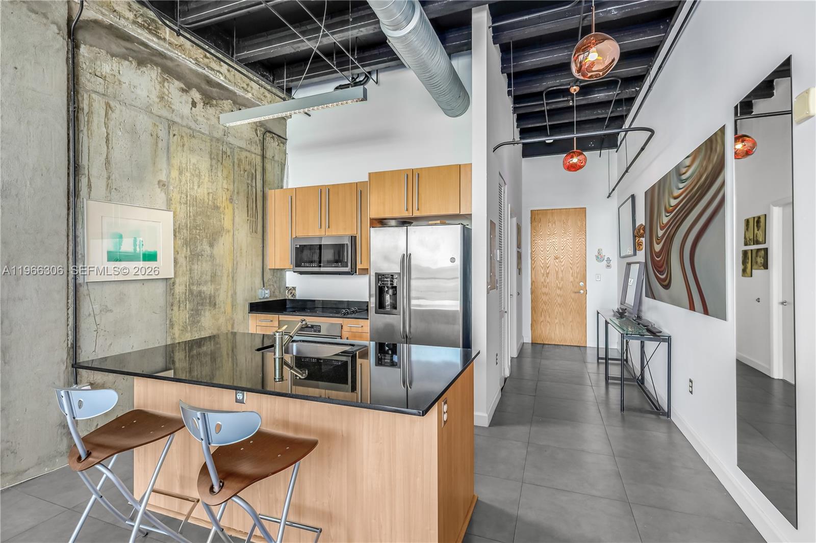 8101 Biscayne Boulevard, Unit R613 Miami, FL 33138 - Photo 7 of 33 a kitchen with stainless steel appliances granite countertop a stove and a refrigerator