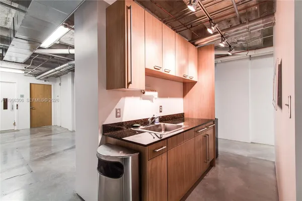 a kitchen with stainless steel appliances granite countertop a stove a refrigerator and a microwave