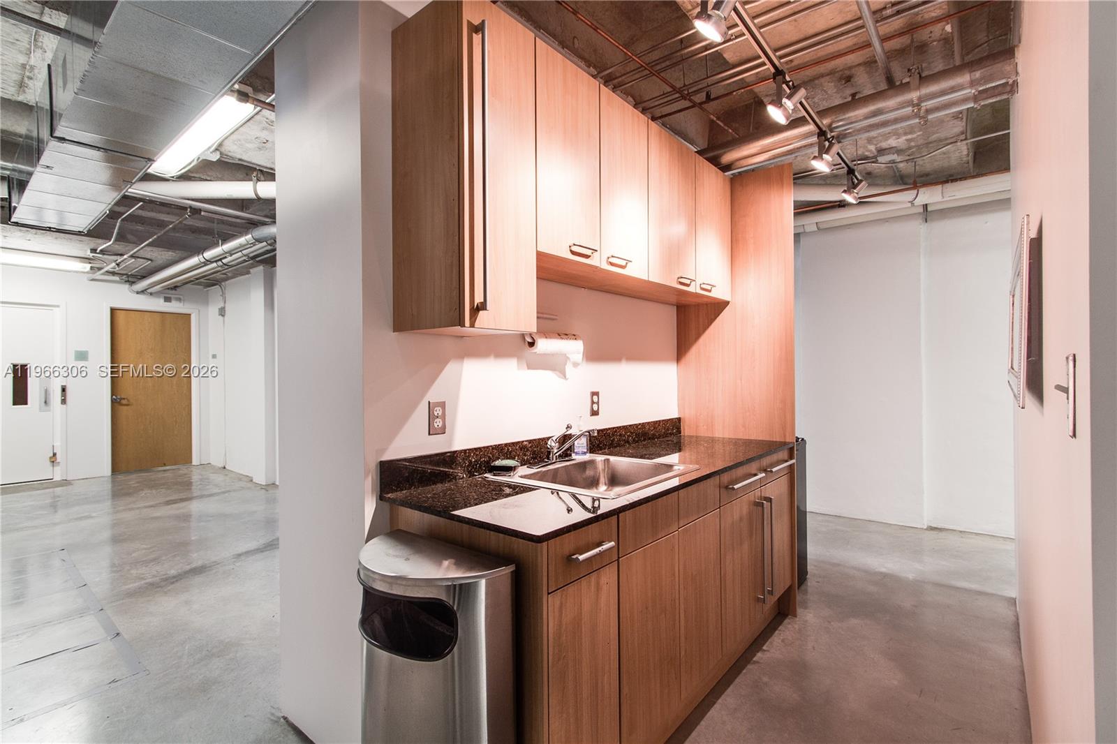 8101 Biscayne Boulevard, Unit R613 Miami, FL 33138 - Photo 8 of 33 a kitchen with stainless steel appliances granite countertop a stove a sink and a refrigerator