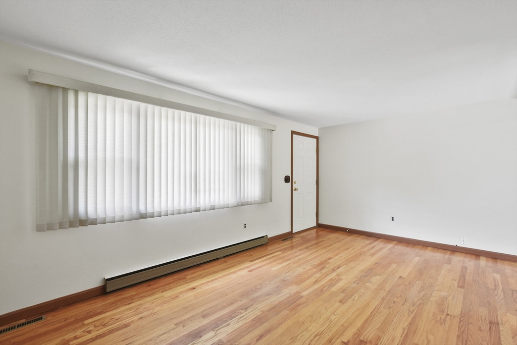 107 Albemarle Road Longmeadow, MA 01106 - Photo 3 of 28 an empty room with wooden floor and windows