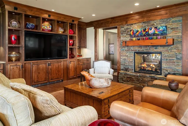 a living room with furniture a flat screen tv and a fireplace