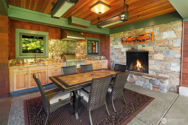 a dining room with furniture a fireplace and wooden floor