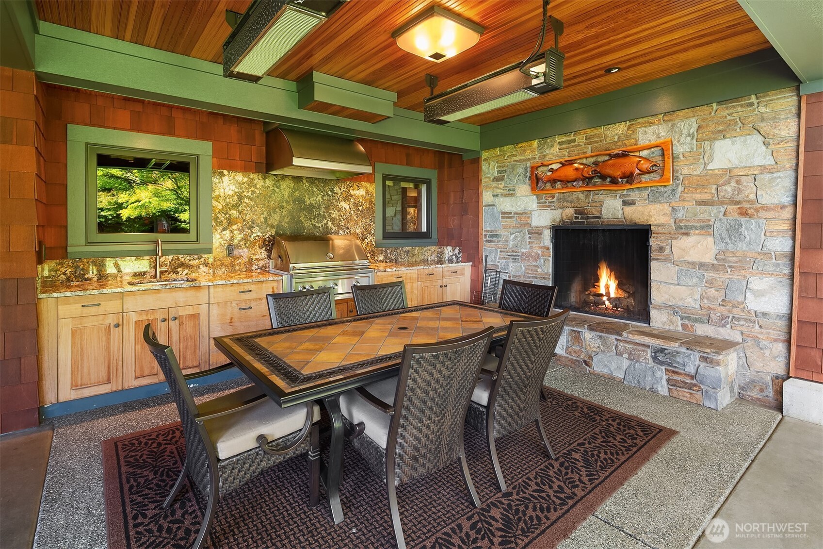 5844 Mutiny Bay Road Freeland, WA 98249 - Photo 24 of 35 a dining room with furniture a fireplace and wooden floor