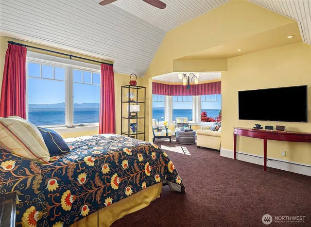 a bedroom with bed and a flat screen tv