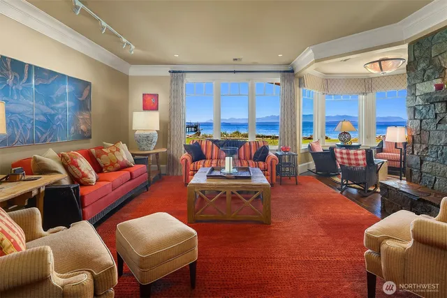 a living room with furniture kitchen view and a large window