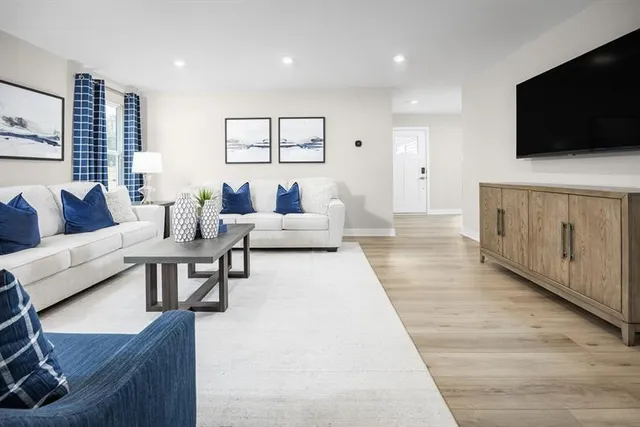a living room with furniture and a flat screen tv