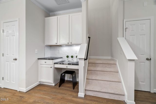 a view of a kitchen with a sink and wooden floor