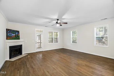 a view of an empty room with a fireplace and a window