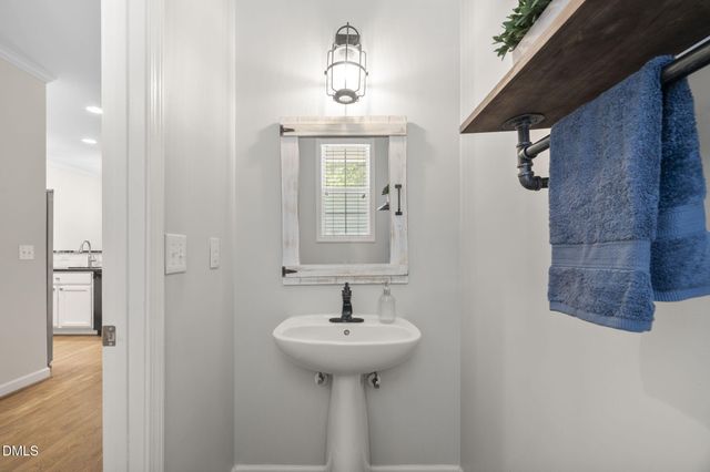 a view of hallway with wooden floor and chandelier